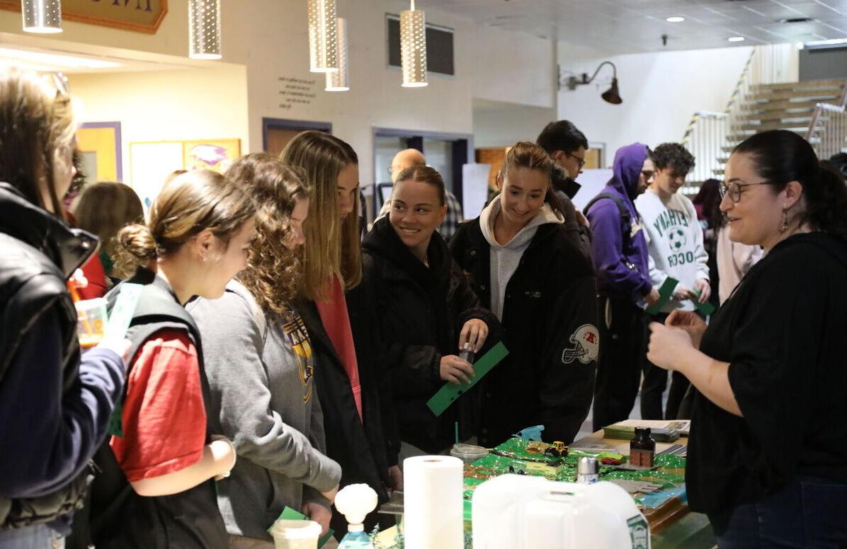 Students smile 和 laugh as they stop by one of the tables during the 2024 Climate Teachi-In